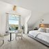 Franziska Haus Dundee bedroom with king bed, seating area and balcony view