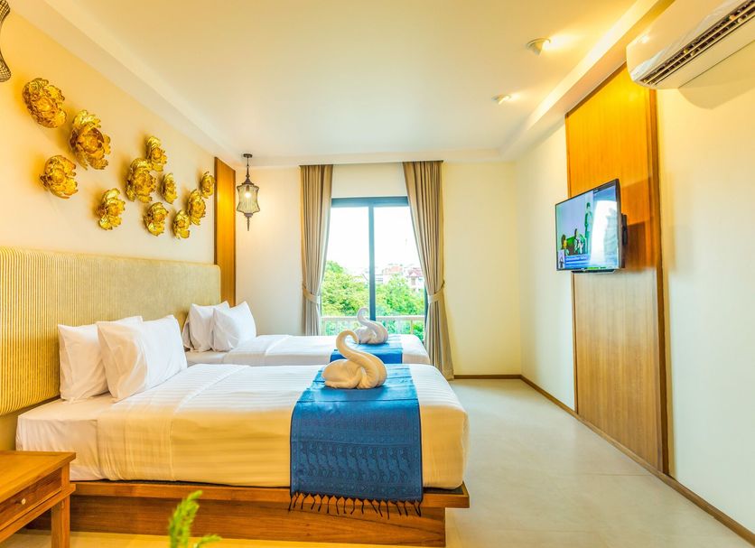 The Signature Hotel @ Thapae in Chiang Mai: twin beds, window view, and wall-mounted TV in a bright room