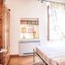 Alla Torre Del Barbarossa B&B Foresteria bedroom with wrought-iron bed, window and wardrobe in Mandello del Lario