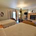 Lakeside Bed & Breakfast in Florence guest room with two four-poster beds and a fireplace