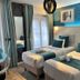 Hôtel Clairefontaine Paris twin guest room with teal accents and balcony doors