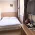 Center Of City Creo Hotel, Yanbian guest room with bed, wall-mounted TV, and window alcove