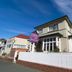 Kiwi's Nest Budget Accommodation & Backpackers in Dunedin, exterior with white picket fence and sign
