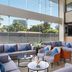 Golden Tulip Westlands Nairobi lobby lounge with gray sofas, blue pillows, and large windows in Nairobi