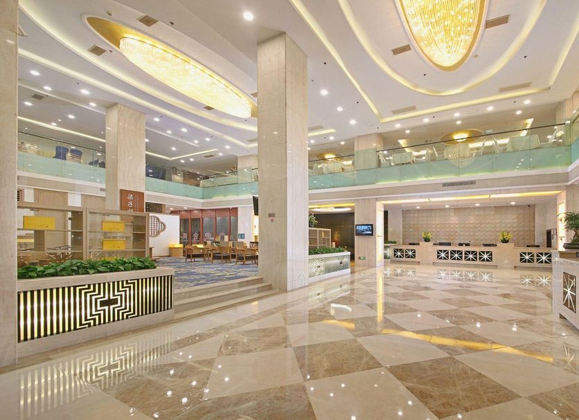 The Greenway Hotel Xiamen lobby in Xiamen with polished marble floors, high ceilings and modern reception desks