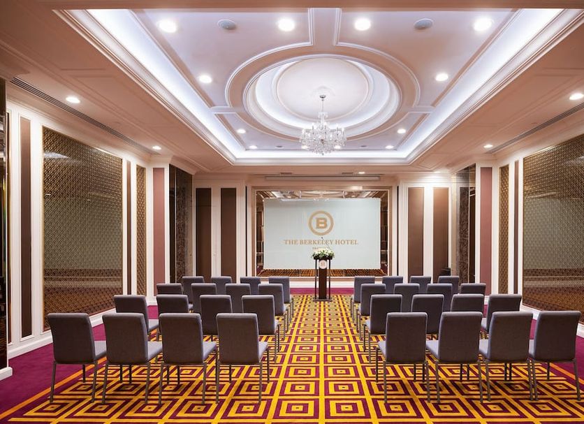 The Berkeley Hotel Pratunam Bangkok conference room with rows of chairs and ornate ceiling