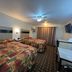 Deluxe Inn Capital O Nebraska City I 29 room with two beds, wall TV and curtained window