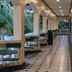La Planta Hotel And Restaurant in Bais City: covered outdoor corridor with arches and patio seating