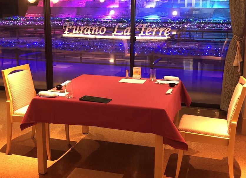 Spa&hotel Resort Furano La Terre restaurant table by window with night view in Nakafurano
