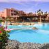 Rehana Sharm Resort in Sharm el-Sheikh with a large lagoon-style pool and palm-lined bridge