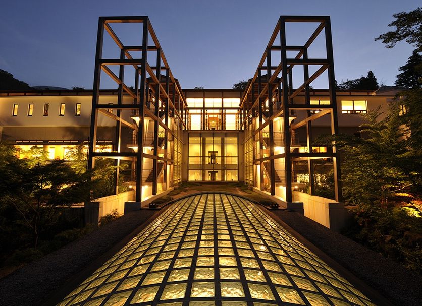 Gora Kadan in Hakone entrance walkway with illuminated glass canopy and modern facade at dusk