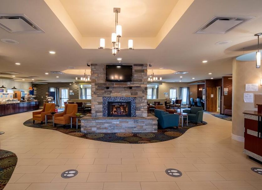 Holiday Inn Express & Suites Pittsburgh Airport lobby with stone fireplace and seating area in Pittsburgh