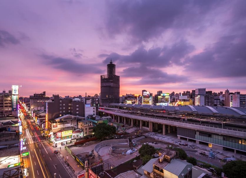 Twinstar Hotel in Taichung City with city skyline and train station at sunset