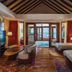 Atmosphere Kanifushi Maldives room with ocean view, twin beds, seating area and balcony doors in Kanifushi