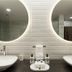Origen 438 Luxury Boutique Hotel in Guadalajara bathroom with twin vessel sinks and round backlit mirrors