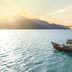 An Lam Retreats Ninh Van Bay in Thon Dam Van with a boat on a calm bay at sunset
