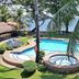 Mike's Dauin Dive Resort in Dauin, pool and hot tub with ocean view, palm trees and loungers