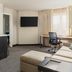 Residence Inn by Marriott Dayton Vandalia guest room with work desk, sofa, TV, and kitchenette