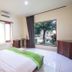 Mirah Hotel & Resort Banyuwangi room with large window, garden view, and king bed