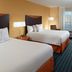 Fairfield Inn & Suites by Marriott Clarksville guest room with two beds, desk, and window view