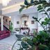 La Panoramica Hotel in Castellammare di Stabia lobby with red leather sofa, ornate mirror, and plants