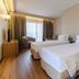 Nova Cruz Hotel in Santa Maria da Feira room with two single beds, armchair, and window curtains