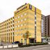 Comfort Hotel Tomakomai in Tomakomai, yellow mid-rise hotel exterior with parking lot