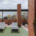 Travelers Orange Suites in Medellín rooftop terrace with loungers and city views