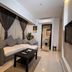 Helio Cairo Hotel in Cairo guest room with sofa bed, coffee table, wall-mounted TV, and bathroom doorway