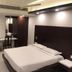 Hotel Maurya International Chennai guest room with double bed, desk, wardrobe and ceiling fan