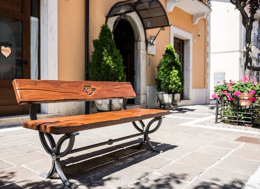 Hotel Il Tiglio in Castel di Sangro with a wooden bench outside the entrance