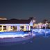 Christofinia Hotel in Ayia Napa with illuminated pool, palm trees and evening resort terrace