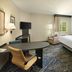 Candlewood Suites Charleston - Northwoods By IHG guest room with queen bed, work desk, TV and window chair