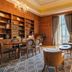 Pousada de Lisboa in Lisbon, elegant wood-paneled lounge with bookshelves, seating area and chandelier