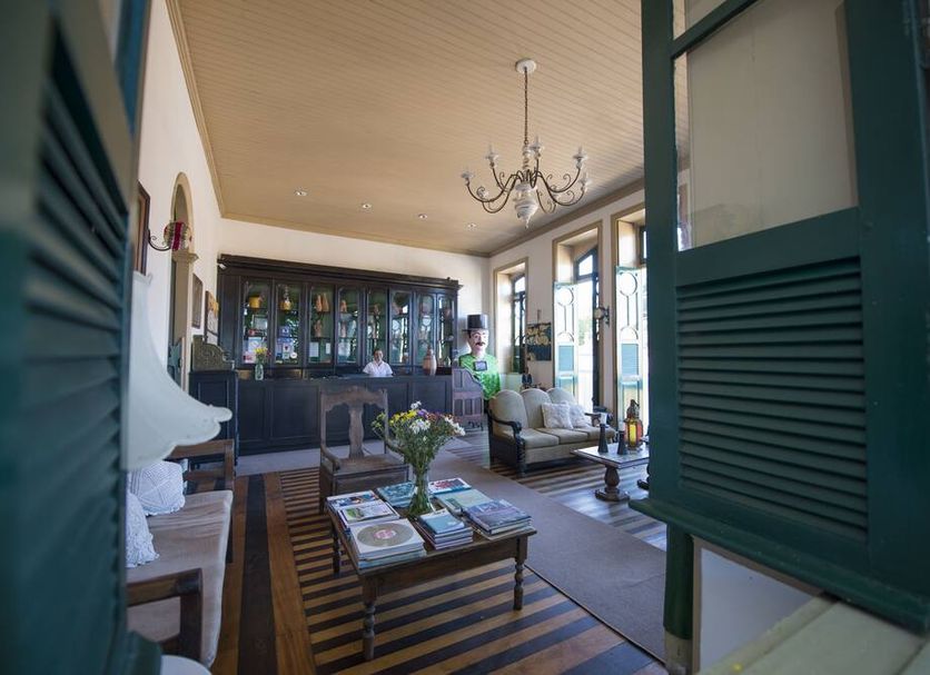 Pousada dos Quatro Cantos in Olinda: elegant lounge with chandelier, sofa seating, and open shutters