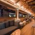 Hotel Principe Delle Nevi lounge in Breuil-Cervinia with wood-paneled interior and stone fireplace