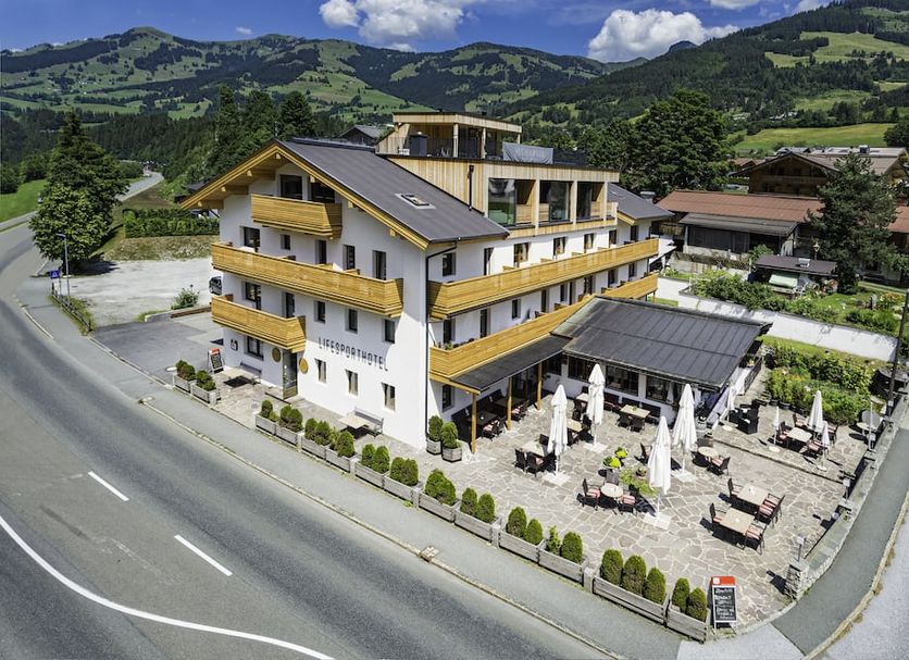 Lifesport Hotel Hechenmoos in Kitzbühel with outdoor terrace and mountain backdrop