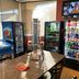 Red Carpet Inn Elmwood Park convenience area with snack and drink coolers, table, and TV