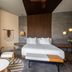 Secrets Tulum Resort And Beach Club room in Tulum with king bed, wicker chairs and modern decor