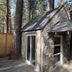 Emerald Bay Lodge in South Lake Tahoe: stone cabin with large tree trunk passing through covered entry
