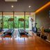 Oriental Hills Okinawa in Onna gym with treadmills, exercise bikes and floor-to-ceiling forest views