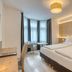 Hotel Leipziger Hof Innsbruck guest room with twin beds, desk and large windows