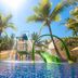 Mulia Resort, South Kuta: tropical hotel pool with colorful water slides and palm trees