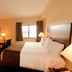 Cobblestone Inn & Suites - Denison guest room with king bed, desk, TV and window view