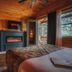 Motel Long Lake and Cottages room with fireplace, wood-paneled walls, and balcony view in Long Lake