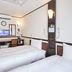 Toyoko Inn Narita Airport Honkan room in Narita with two twin beds and a desk