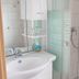 Hotel Ackermann, Riedstadt bathroom with sink, mirror, glass shower screen and handheld shower