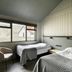 Hotel Katla by Keahotels in Vik guest room with twin beds and a large window view