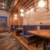 Sandman Signature Ottawa Airport Hotel dining booths with warm pendant lights in Ottawa