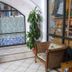 Hotel Casa Vieja in Puerto Escondido patio with wicker chairs, potted plant and arched windows